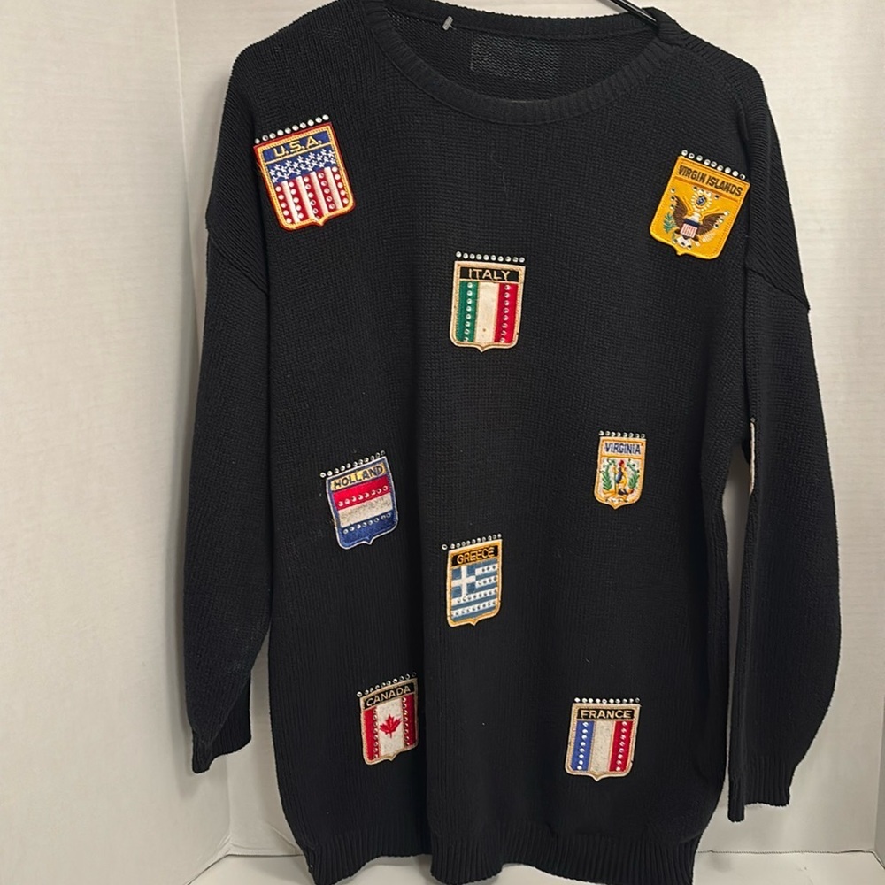 BLACK SWEATER…WITH PATCHES OF  PLACES AROUND THE WORLD
NO TAGS COULD BE
VINTAGE